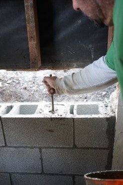 Where vertical rebar extended up from the footing, the crew packed the cores of the block with grout.  