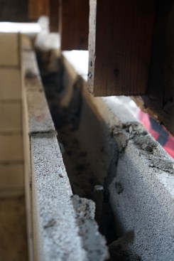 The masons capped the walls with a course of bond beam blocks, which were tied to the lower block courses with short lengths of rebar. 