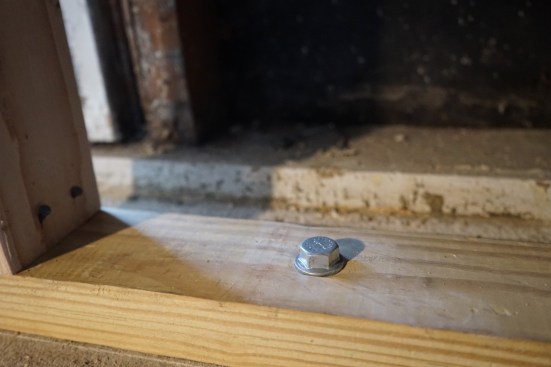 The crew anchored the mudsill to the new foundation with Simpson Titen bolts. 