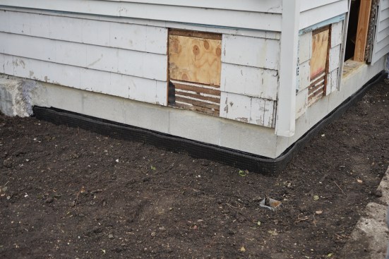 Once the topsoil was in place, the only remaining task was repairing the beam holes in the siding. 