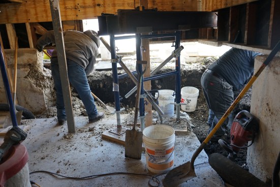 After tearing back the existing walls to solid concrete, the crew began excavating for the footings. 