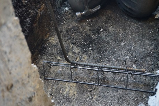 The new footing was reinforced with 1/2-inch rebar, which was tied to chairs pinned to the base of the footing trenches.  