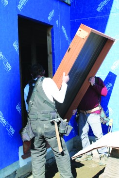 Carefully slip the door into the opening, keeping movement of the door to a minimum.