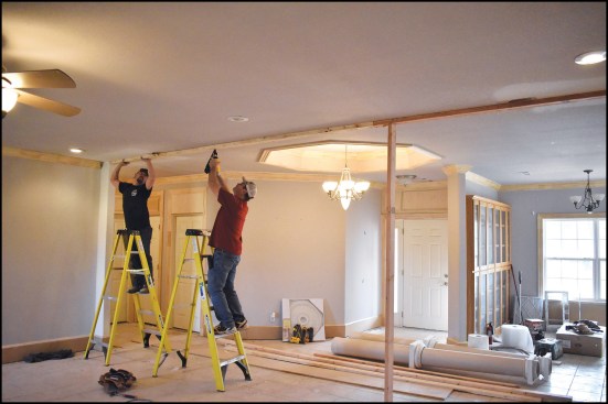 The crew began by fastening 2x4 cleats to the ceiling directly underneath an LVL beam that supports the second-story floor framing.