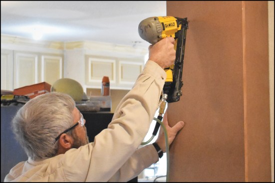 The author fastened an MDF panel to the wall underneath each beam end, building out the pilaster detail with short MDF returns as needed.