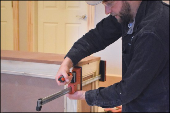 … and vertical 2x4 blocking were added to support the columns, the end panels were glued, pinned, and clamped into position.