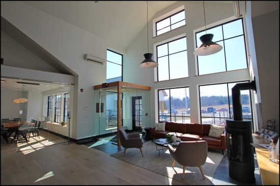 In the second-floor entry, which is open to a third-floor mezzanine, wall-mounted units heat and cool the reception area …