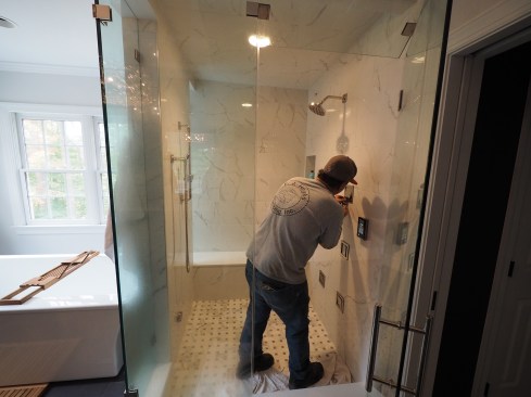 Enclosures for steam showers need to be fully water- and vapor-proofed on all sides. Surfaces, including ceilings, are typically tiled, and large areas of glass (door, side, and top wall panels) are used to let in outside light and increase ambiance.