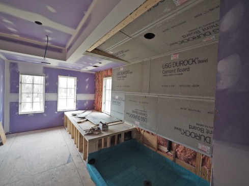 A soffit hides the sloped ceiling on an in-progress installation.