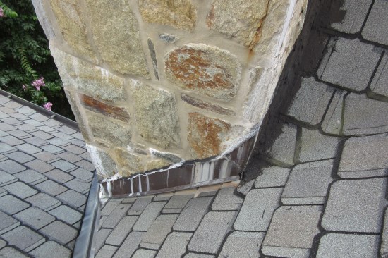 The base flashings along the side are efflorescence-stained.
