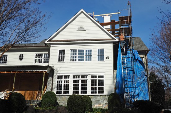 A waterproof cement-based coating (MasterSeal 581) is applied up and over the block chimney core. (DuPont FlexWrap was installed at the stepped-block base as a temporary waterproofing, then later replaced with Textroflash peel-and-stick.)