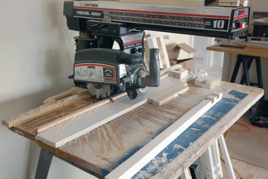 The three-piece baluster assemblies fabricated on site required two half-laps in the middle baluster. 

To ensure consistency, two 1-by stops positioned on the radial arm table were used to cut 1 1/4-inch-wide plows. 