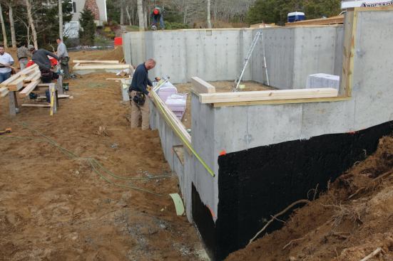 It's important to pull stud locations from the same corners as those we will use to pull joist and rafter locations. That allows us to easily stack studs, joists, and rafters, providing for direct load bearing from roof to foundation. This also creates the clearest possible stud bays, which makes life a bit easier for the mechanical trades that will follow behind us.