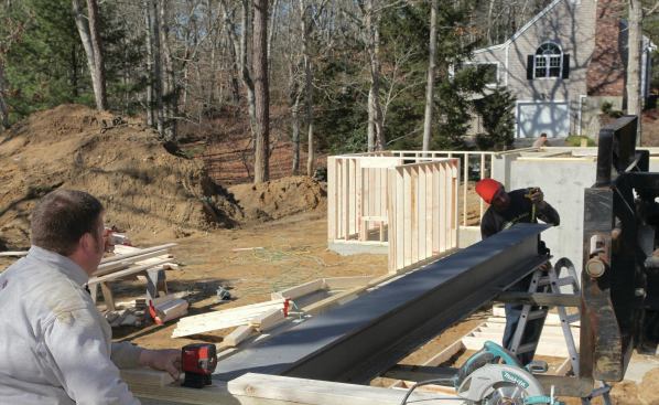 Using our laser and the telehandler, we level the beam.