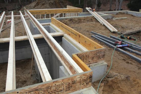 For the rim running perpendicular to the joists, we typically install an engineered rim board material that's compatible with the I-joists, and on the load-bearing sides running parallel to the joists we install an equivalent size LVL.