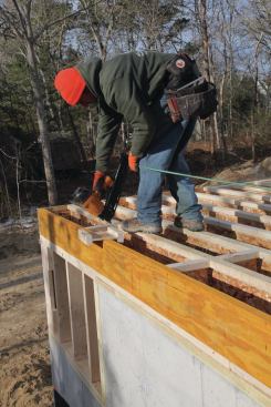 While the rim was being installed, we also installed all of the necessary blocking. Blocking at 16-inch centers is required to support the exterior walls on the LVL sections of the rim. Blocking and web stiffeners are also required for any intermediate load-bearing walls, which we had above our midspan girder.