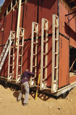Cantilevered wall trusses screwed to the framing provide space for insulation.