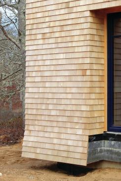 The shingles covering the wall trusses flair out to help disguise the overhang.