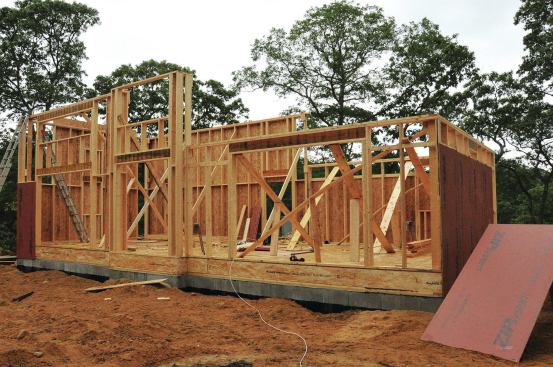 The tall walls on the house were balloon framed at full height. Walls for the bedroom on the right were platform framed after the ceiling beams had been installed.