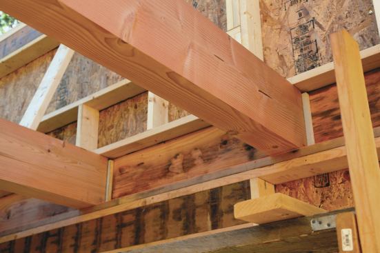 Rigid foam inserted at the ends of the fir beams provides a thermal break at the exterior walls.