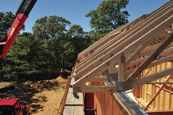 The raised heel on these roof trusses provides room for lots of insulation while the scissor chords create a vaulted ceiling for the rooms below.