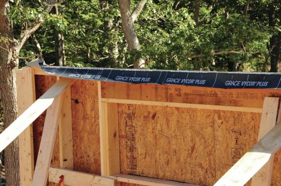 At the top plate, the air barrier switches from the exterior sheathing to the plastered ceiling. Vycor wraps from the sheathing over the plate.