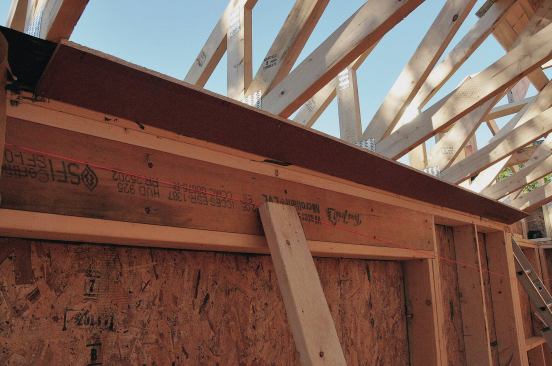 After the trusses are installed, strips of OSB go in around the perimeter of the ceiling with the Vycor adhered to the top side.