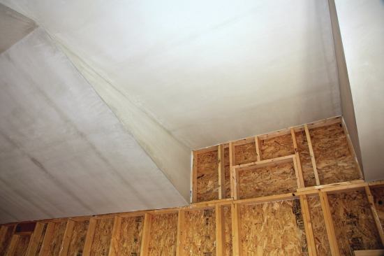After the drywall is bedded in sealant and attached to the ceiling, a skimcoat of plaster completes the air barrier.