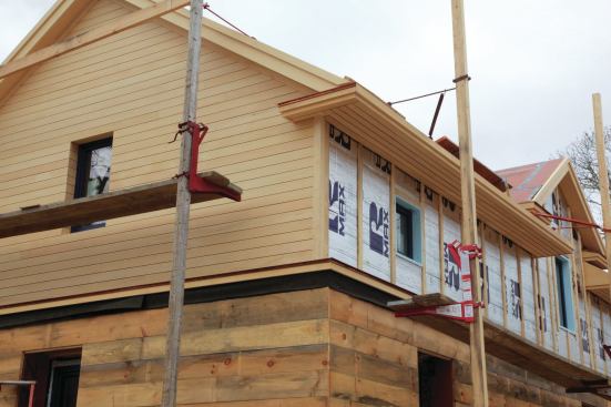 Vertical furring strips provide attachment for the siding above the wall trusses. The rigid foam is the drainage plane for that part of the wall.