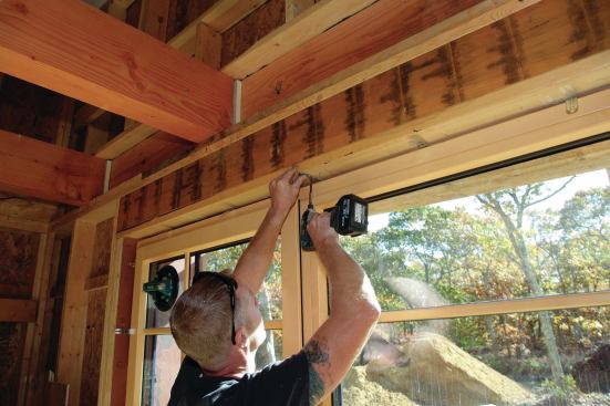 Special metal brackets screwed to the window before positioning secure it to the framing.