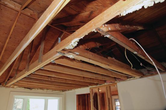 The builder had then suspended the ceiling-joist support beam from the rafters above using vertical 1x6s. The problem was compounded by the fact that both ridges were non-structural. These techniques were right out of the Rube Goldberg school of home building.