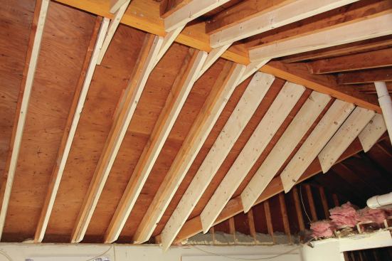 My goal was to keep the original unvented roof intact, so for insulation, we decided to use 10 inches of spray foam to give us the required ceiling R-value without venting. To get enough depth, 2x10 rafters were sistered onto each of the original 2x6 rafters, using framing nails and Timberloks.