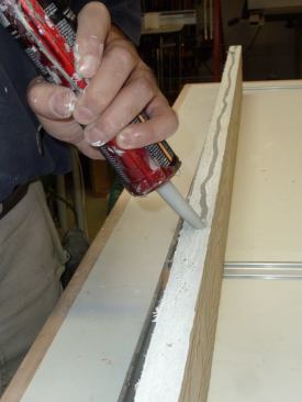 After coating the cut edges with primer, run a bead of sealant along the long edge of the ripped piece.