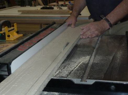 Rip down, by the thickness of the material, the corner board that will be less visible.