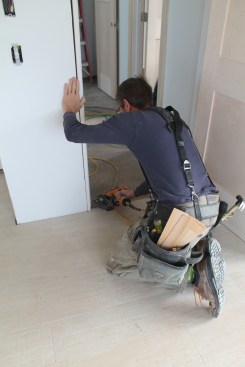 Next drive a single nail into each of the other three corners to hold the door in the opening.