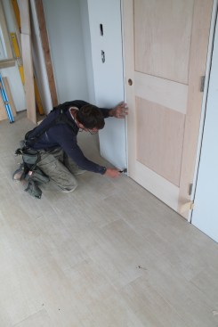 When the hinge jamb is straight and secure, turn your attention ot the strike jamb. Starting at the bottom adjust the jamb leg in or out until the gap between the jamb and the slab is even. Then snug shims behind the jamb near the floor before driving nails.