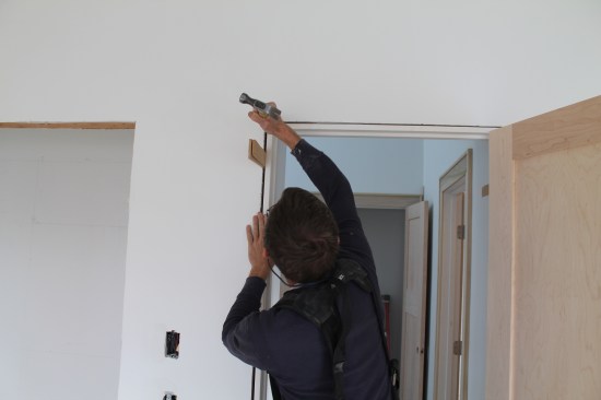 Adjust the slab/stop alignment with a gentle tap on the corner of the jamb. When the door hits the stop perfectly, drive additional nails to hold the jamb in place.