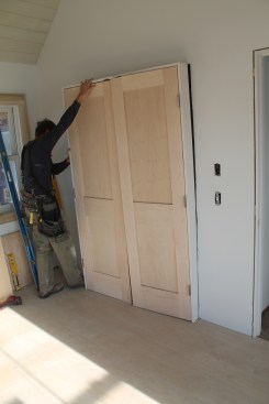 As with a single door, set the door in the opening—this time with the temporary fasteners removed.