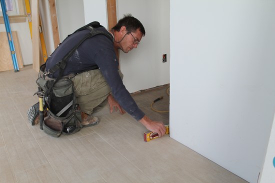 The final check is that the floor is level under each jamb leg. If it's sloped, the cut should be adjusted accordingly.