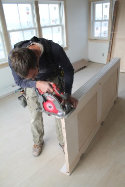 After cutting the first edge, flip the door over and repeat the process with the other jamb leg. Be sure the hinge screws aren't coming through the jamb on the other side—they can ruin a finished floor quickly!