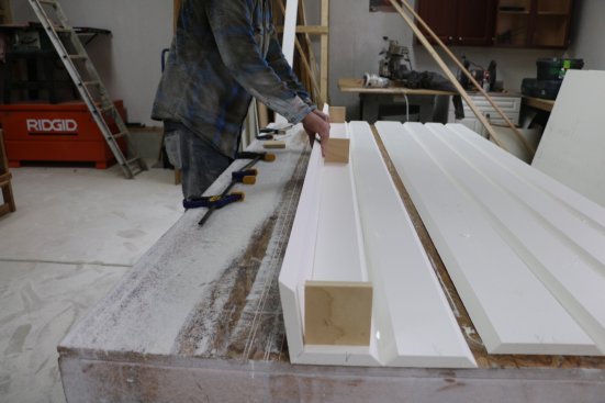 When the glue is still wet, fold the three sides onto square wooden forms.