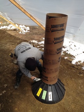 After the wide base form is cut to the proper diameter, a concrete tube form is screwed to it.