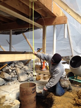 The height of the form is measured from the underside of the structure and marked on the concrete tube.