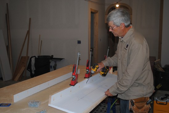 The pilasters that flank both sides of the firebox are designed to look like columns. The author screws and glues together U-shaped pieces that act as the foundation for the pilasters.