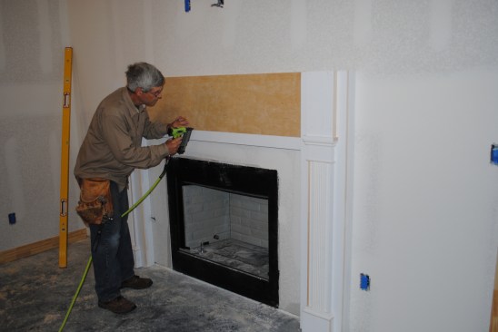 Then he adds a built-up panel between the pilasters.