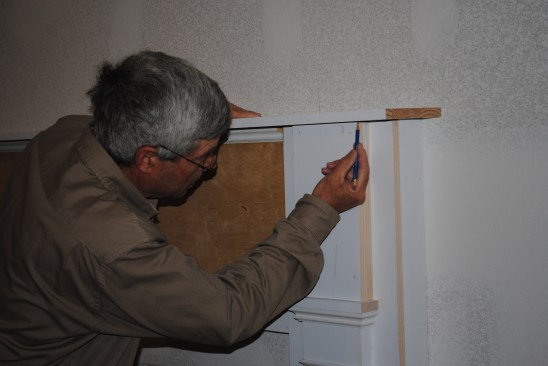 The author scribes the mantel shelf to the pilasters and panels.