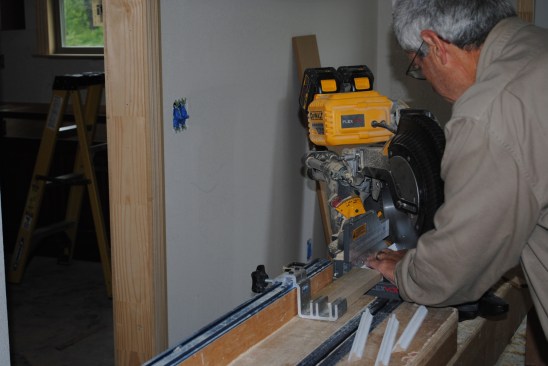 The molding is carefully cut on a miter saw using a stop.