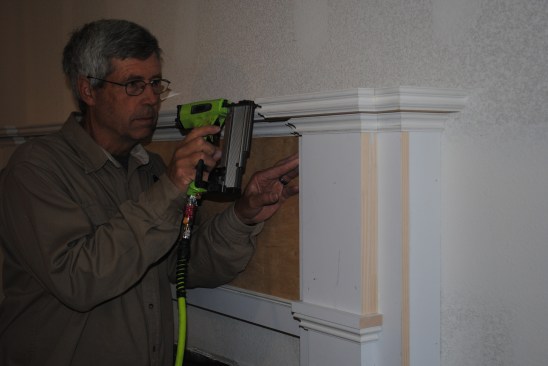 Another band of molding wraps around the edge of the mantel shelf, as well, following the contours of the pilaster below.