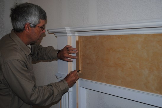 Molding outlines on the flat surfaces create a paneled look. A spacer block positions the preassembled side pieces.