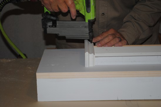 To complete the columned look, each reeded section receives a base and a capital. After finishing the bottom of the reeded section with a 1-by block, the author wraps the block with panel molding.